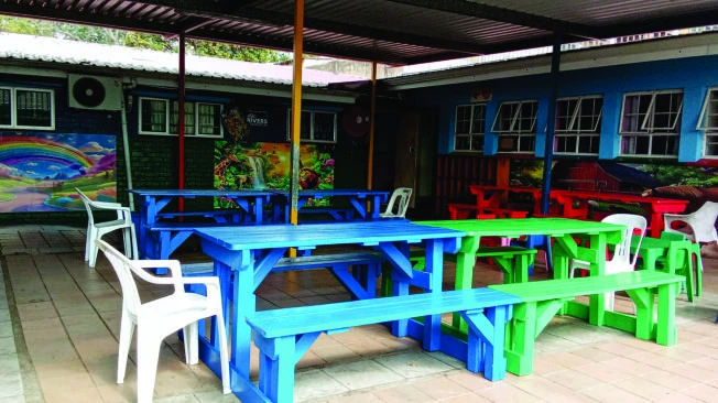 Colourful outdoor tables in the courtyard at St Thomas Home